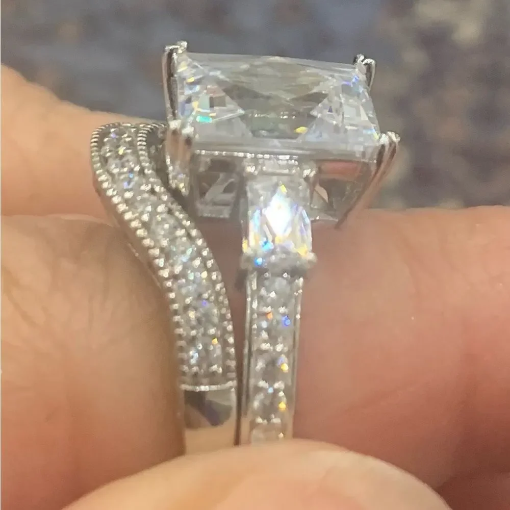 Lovely emerald cut solitaire with a pretty ring guard . Size 9 . Rhodium plated